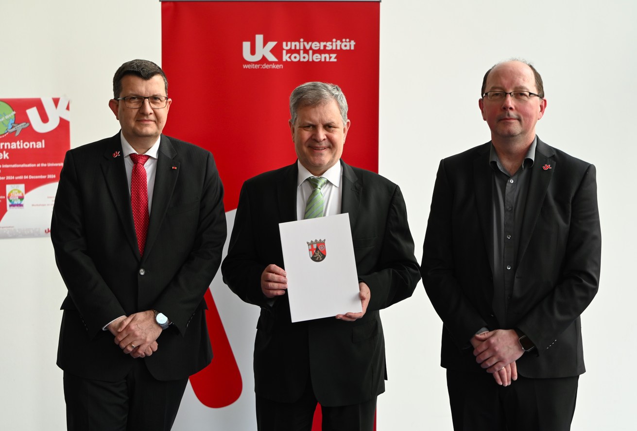 Dr. Ralf Geis, Präsident des Verwaltungsgerichts Koblenz, wurde zum Honorarprofessor ernannt. Universitätspräsident Prof. Dr. Stefan Wehner (li.) und der Dekan des Fachbereichs 4: Informatik, Prof. Dr. Ralf Lämmel (re.), überreichten die Urkunde. Bild: Universität Koblenz/Judith Böseke